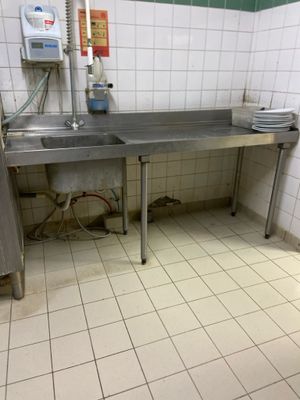 a kitchen with a sink and a counter in it