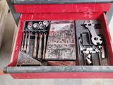 a red tool box with a lot of tools inside of it