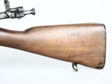 an old rifle with a wooden barrel and a metal handle