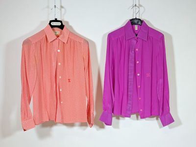 pair of pink and orange shirts hanging on a white wall