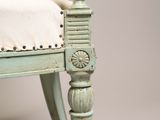 a green chair with a white cushion on it