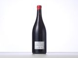 a bottle of red wine sitting on top of a table