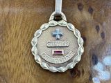 a close up of a silver medal on a wooden surface