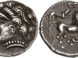 a close up of a coin with a face on it