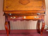 a small wooden desk with a drawer on top of it
