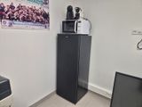 a refrigerator and a microwave in a small room