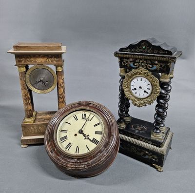 three different types of clocks sitting next to each other on a gray surface