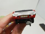 a person holding a small toy car in their hand