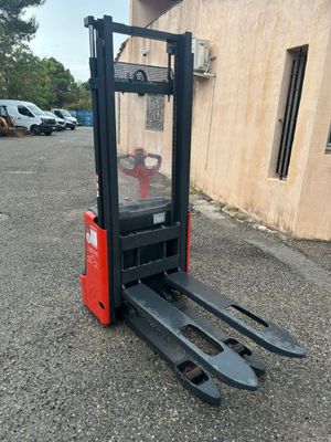 a close up of a forklift parked in front of a building