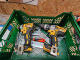 two cordless drillets in a green plastic crate