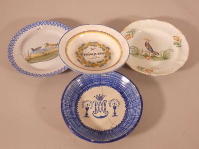 three plates with blue and white designs on them on a table
