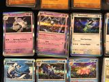 a lot of different pokemon cards on the table