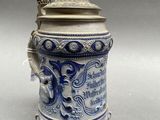 blue and white beer stein with a dragon on the lid