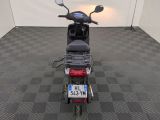 a motor scooter that is parked in a room