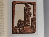 an open book with a picture of a statue on it