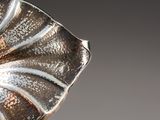 a close up of a silver object on a table