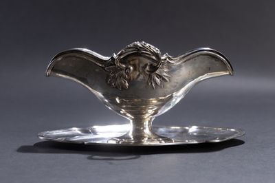 une soucoupe en argent ornée d'une tête de lion