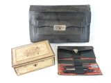 a black leather case with scissors and other items in it