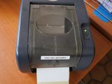 a printer that is sitting on a desk next to a computer