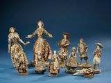 group of figurines of people and animals on a blue surface