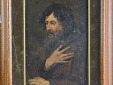 portrait of a bearded man in a brown coat by a wooden frame