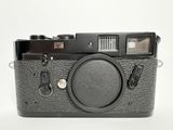 the camera is black and has a black lens on it