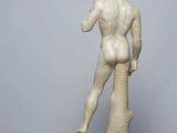 marble statue of a male nude torsoed figure on a marble base