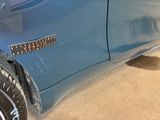 a sticker on the side of a blue car