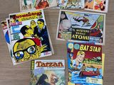 several comic books on a table with a wooden table top