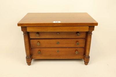 a small wooden chest of drawers with three drawers on each side