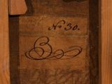 painting of a wooden frame with writing on the bottom of it