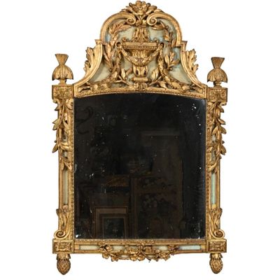 un miroir avec un cadre doré et un miroir sur lequel est représentée une image