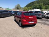 many cars parked in a parking lot with mountains in the background