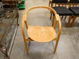 a wooden chair that is sitting in the middle of a room