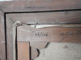 a piece of wood with writing on it in a room