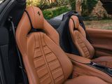 the interior of a sports car with tan leather seats and black trims