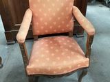 an old chair with a pink upholstered upholstered upholstered upholstered upholstered