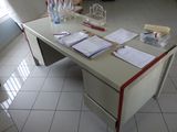 a desk with a bunch of papers on it in a room