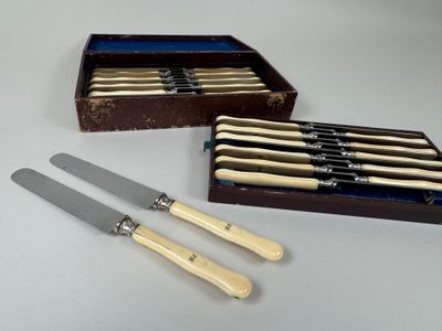 two knives and a box of knives are sitting on a table