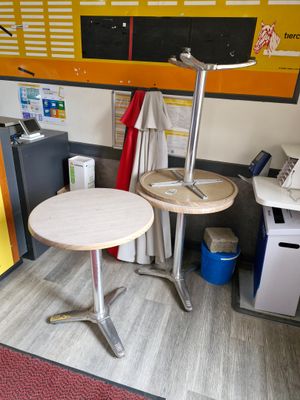 a small table with a lamp on it in the corner of a room