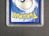 a pokemon card in a plastic container on a table