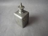 a small metal container with a lid on a table