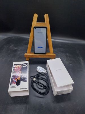 un téléphone posé sur un support à côté d'une boîte
