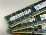 three memory modules are stacked on top of each other on a table