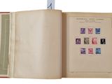 an open book with stamps on it on a white background