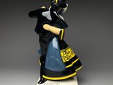 an image of a figurine of a man in a top hat and dress