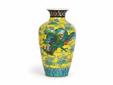 a yellow vase with a blue and green design on it