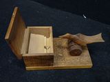 a small wooden box with a bird on top of it