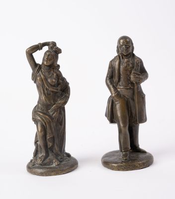 pair of antique bronze figurines of a man and a woman