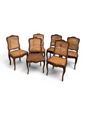 a set of six chairs with cane backrests and cane backrests